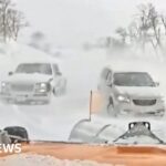 Snowplough used on cars stranded in blizzard conditions