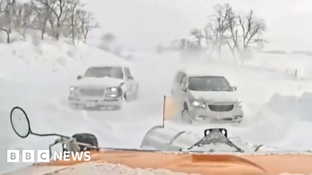 Snowplough used on cars stranded in blizzard conditions