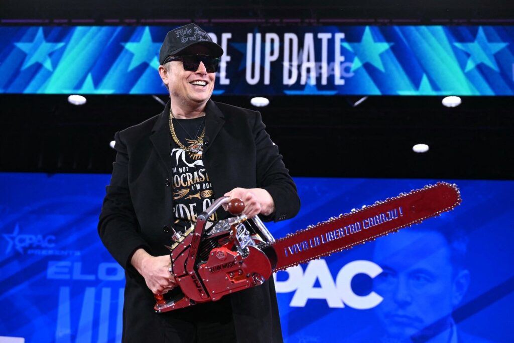 Elon Musk holds a chainsaw reading "Long live freedom, damn it" during the annual Conservative Political Action Conference (CPAC) at the Gaylord National Resort & Convention Center at National Harbor in Oxon Hill, Maryland, on February 20, 2025.