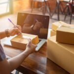 Online shopping young start small business in a cardboard box at work. The seller prepares the delivery box for the customer, online sales, or ecommerce.