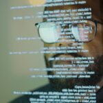 Man studying a see-through display depicting Python computer coding.