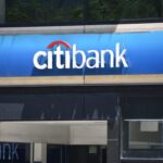 Citibank logo looms over a commercial storefront.