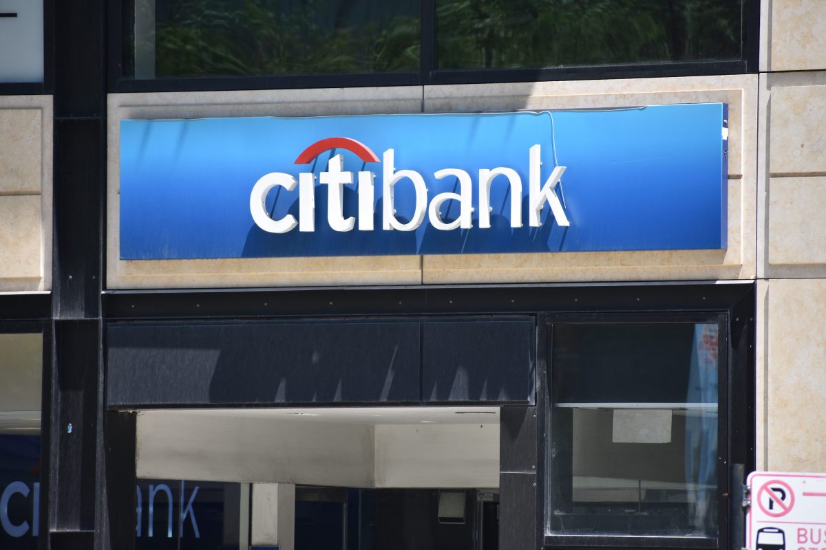 Citibank logo looms over a commercial storefront.