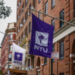 NYU flags hang outside university building