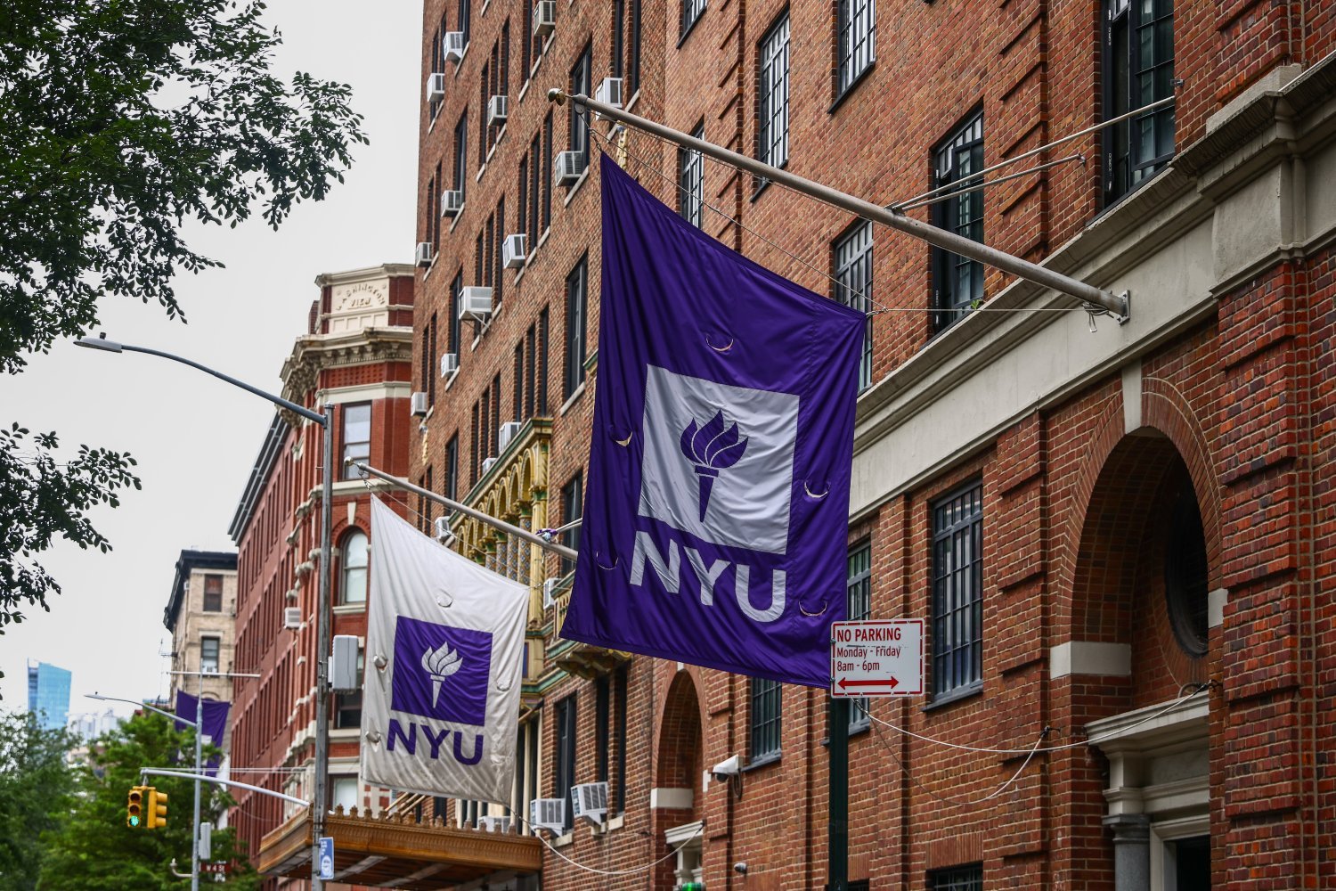 NYU flags hang outside university building