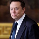 Musk tells Tesla employees hang on to stock after 50% plunge