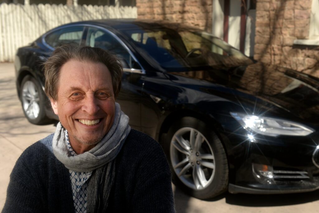 Errol Musk, father of Elon Musk, pictured in front of a Tesla