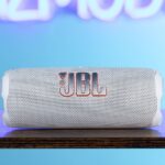 JBL Flip 7 with neon Gizmodo sign