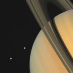 Saturn and two of its moons, Tethys (above) and Dione, as photographed by Voyager 1 on November 3, 1980.