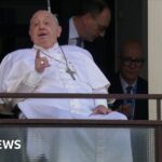 Moment Pope Francis greets cheering crowds from hospital window