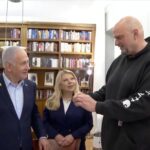 Benjamin Netanyahu gives John Fetterman a pager on March 19, 2025.