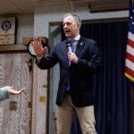 Protesters disrupt, jump on stage during Democrat congressman's town hall