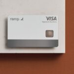 A Ramp Visa Signature Business card is placed on a white and brown surface