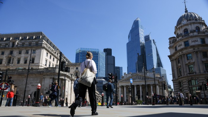 Commuters crossing a junction near the Bank of England