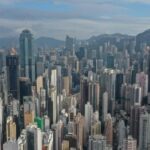 Aerial view of a densely packed Hong Kong skyline featuring numerous residential and commercial skyscrapers