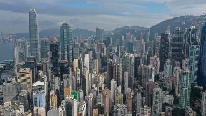 Aerial view of a densely packed Hong Kong skyline featuring numerous residential and commercial skyscrapers