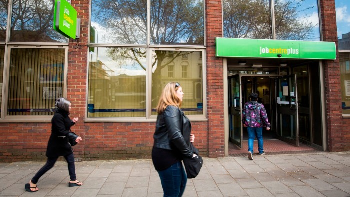 People walk past a Job Centre in Westminster