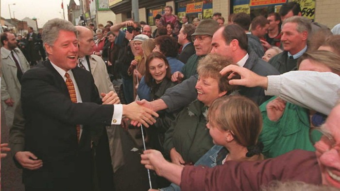 President Bill Clinton meets with residents during a walk through Belfast