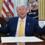 President Donald Trump at his desk in the Oval Office