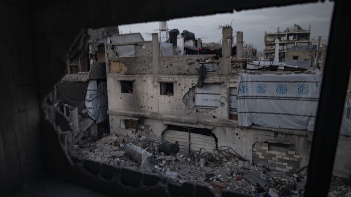 Palestinians among the rubble of destroyed buildings during the holy month of Ramadan in Jabalia refugee camp, northern Gaza Strip