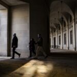 Pedestrians walk past the IRS headquarters in Washington DC