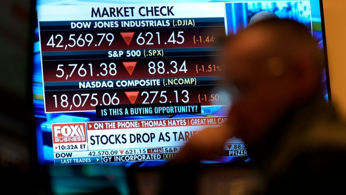 Financial news is displayed as people work on the floor at the New York Stock Exchange in New York on Tuesday, March 4 2025