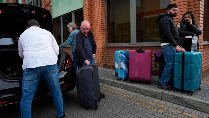 Travellers are left at a nearby hotel after Heathrow Airport closed for the entire day on Friday