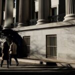 People walk past the US Treasury building