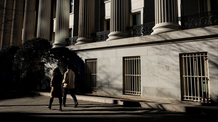 People walk past the US Treasury building