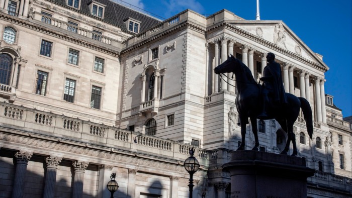 The Bank of England building on Threadneedle Street, London, with its classical architecture and columns under a clear blue sky