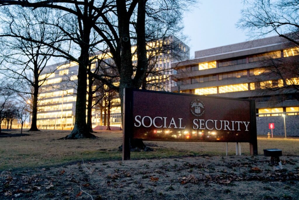 a photo of the U.S. Social Security Administration headquarters at night, with lights on across a series of floors of a building in Maryland